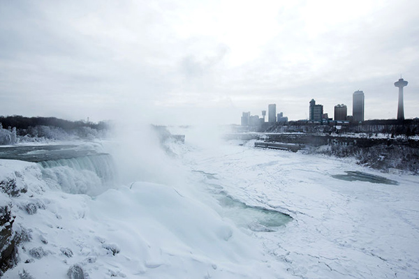 Image: A snow-covered landscape is seen over the frozen Niagara Falls in Niagara Falls, New York