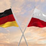 Flags,Of,Germany,And,Poland,Waving,In,The,Wind,On
